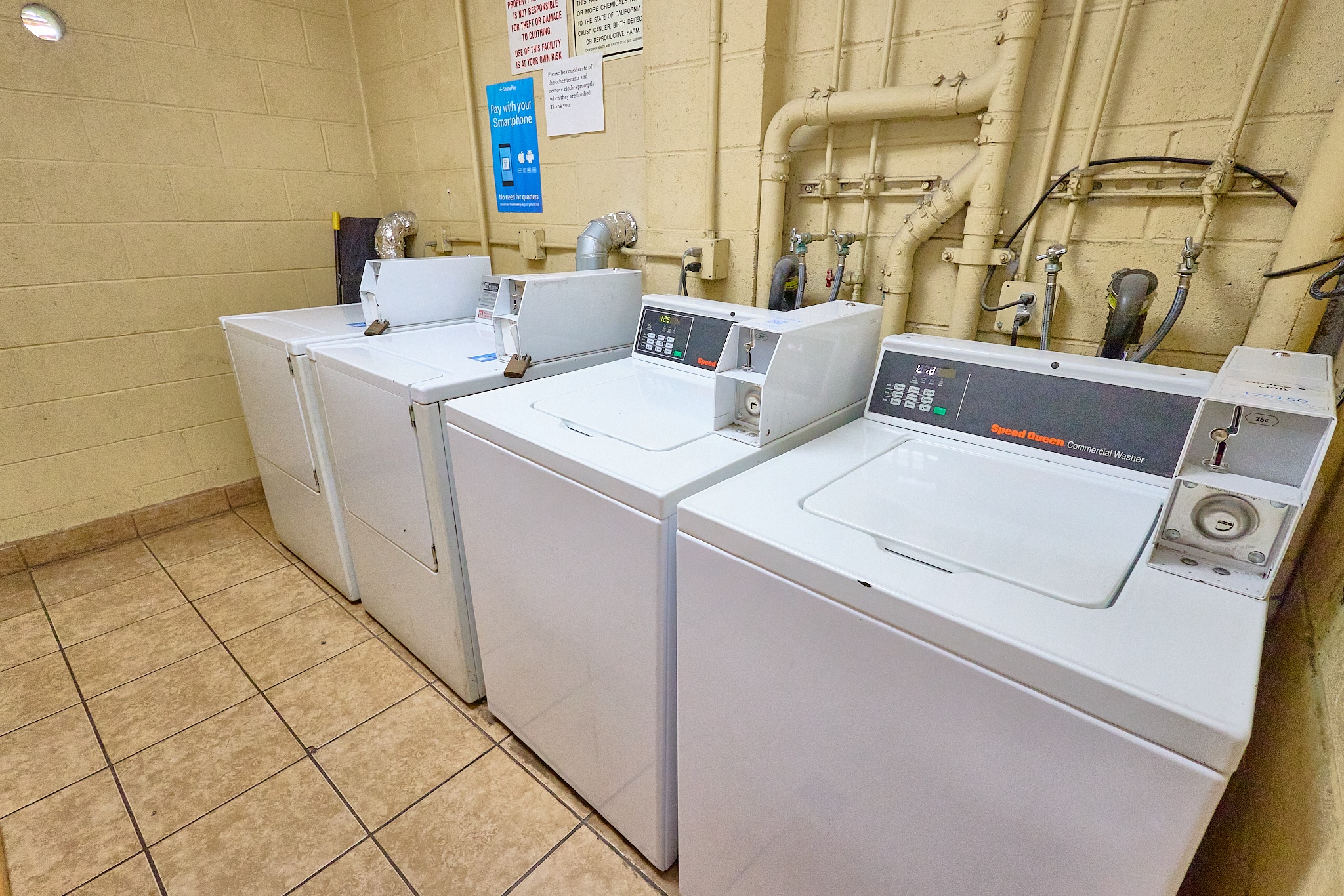 A row of washing machines in a laundromat.